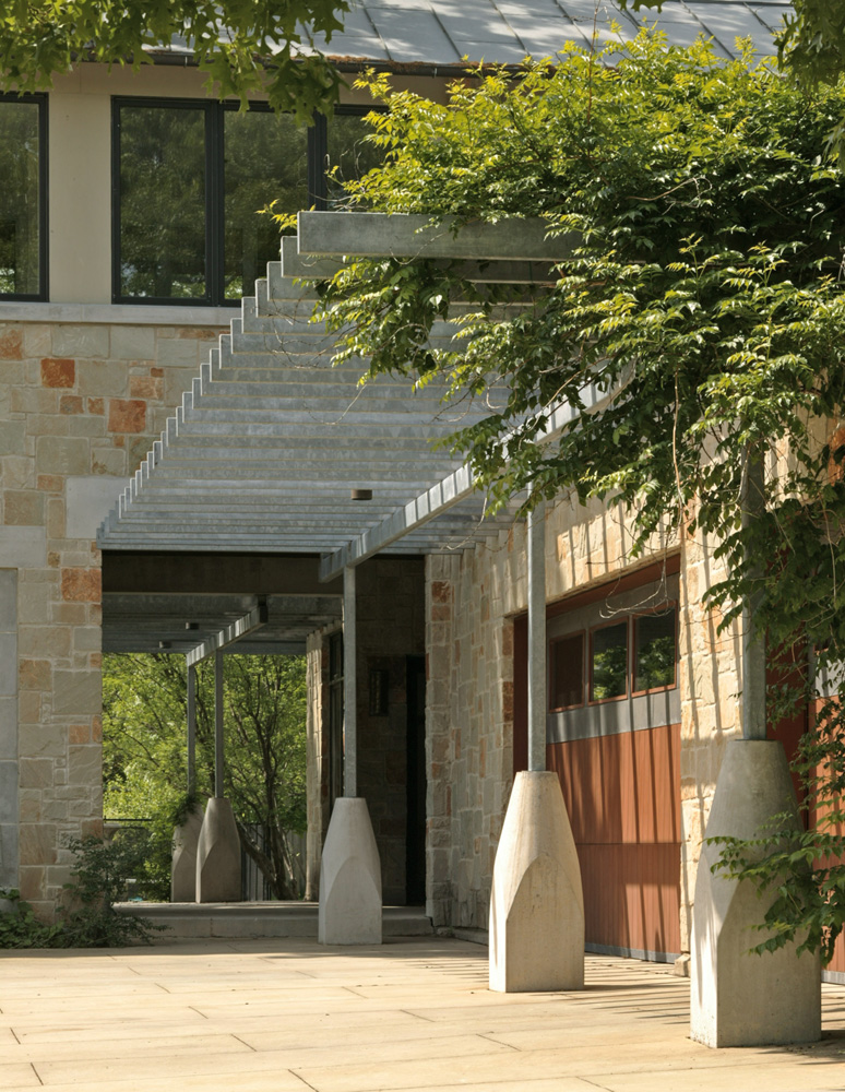 A metal awning outside garage doors of a house.