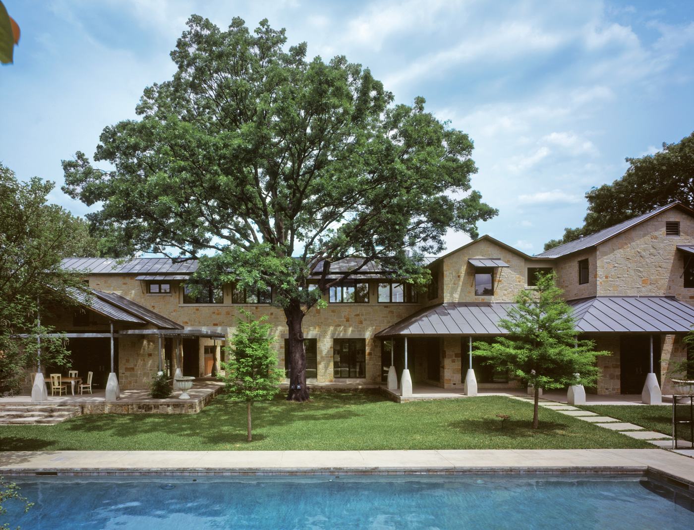 a large house's back yard and pool.