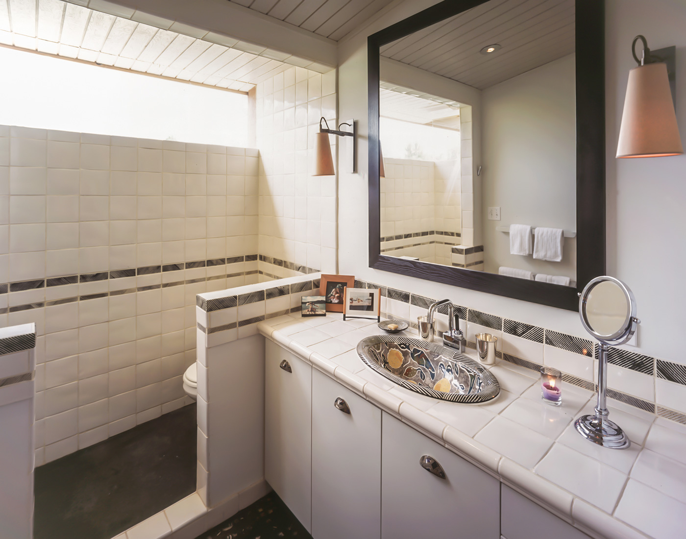 Bathroom with large square mirror.