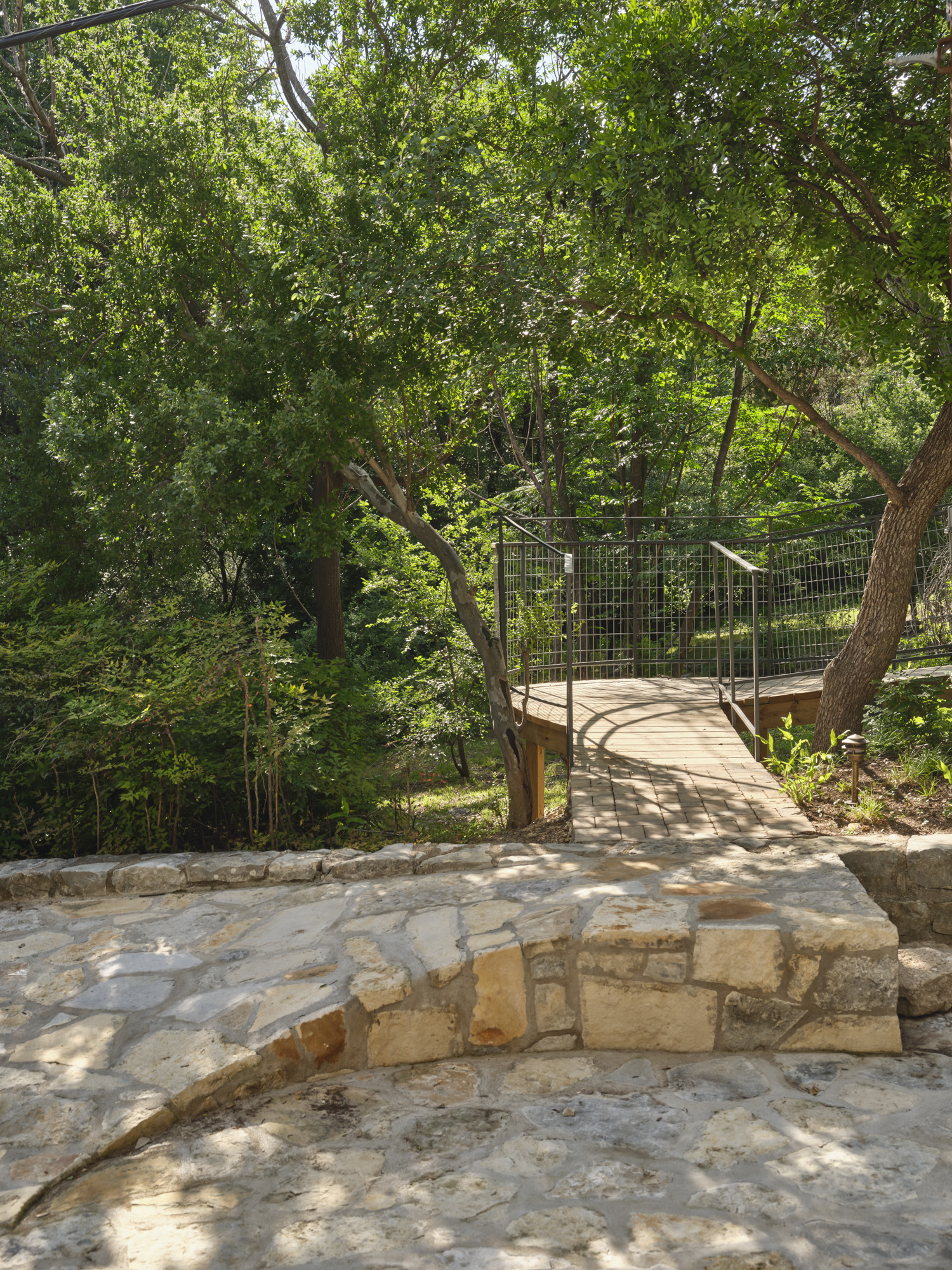 Stone transition to a wood deck ramp.